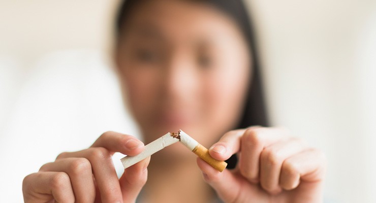 0257_508485417 image of woman breaking a cigarette