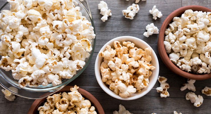 Poporn in bowls on wooden background bowls of popcorn