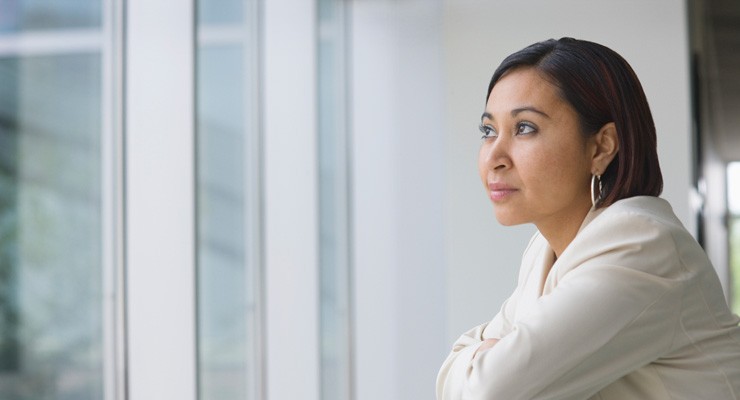 0376_108113763 woman gazing out a building window