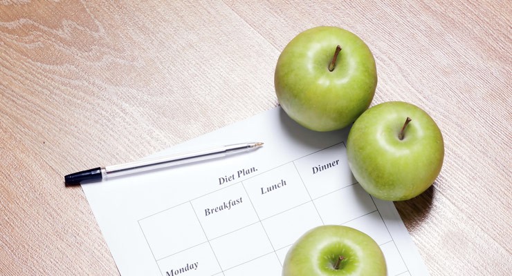 0015_476900341 three apples on top of a chart next to a pen