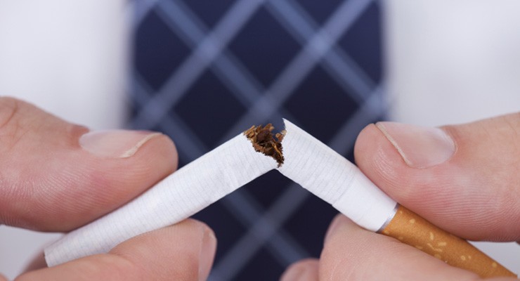 0011_487327931 person breaking a cigarette