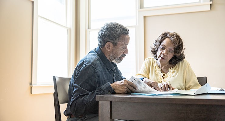 1151623803 image of man and woman sitting at a desk