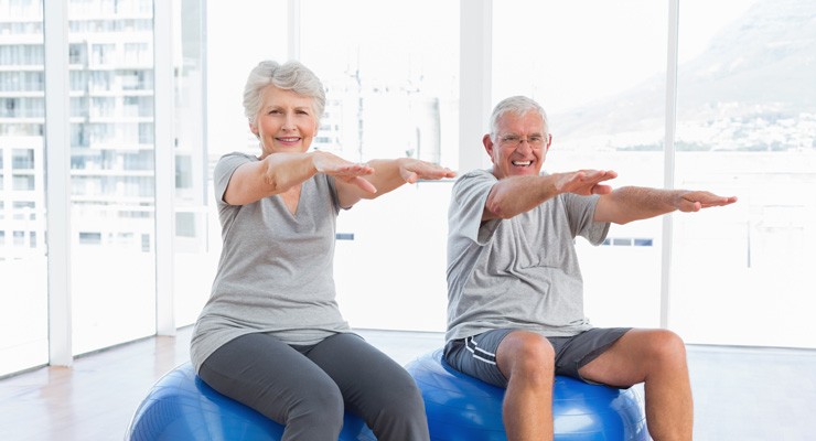 0198_494388953 older man and woman sitting on exercise balls
