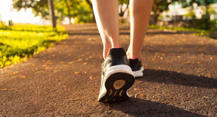 0438_503818820 image of woman's lower legs in sneakers, walking away
