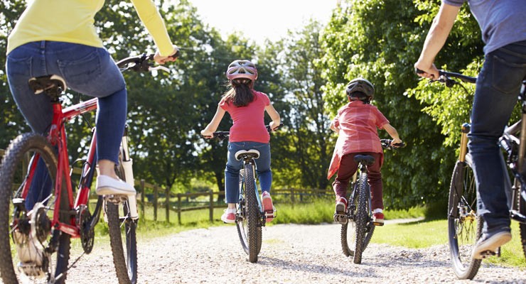 family with children bicycling on path