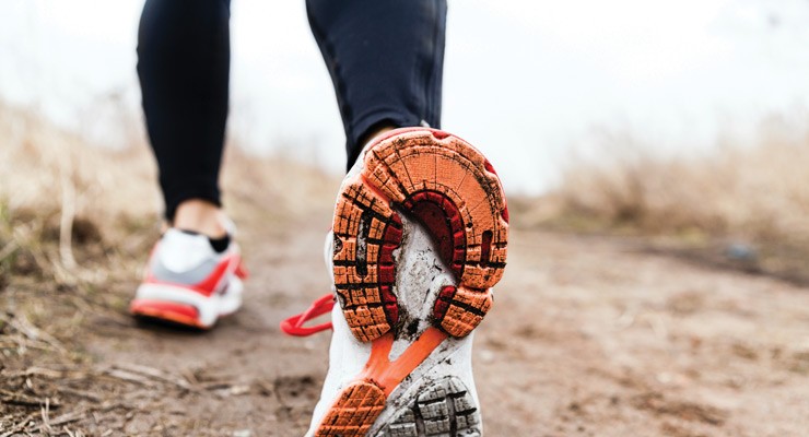 0093_Thinkstock_158762352 image of woman's lower legs in sneakers, walking away