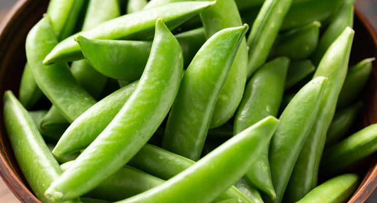 Raw Organic Green Sugar Snap Peas in wooden bowl. ready to eat bowl of snap peas