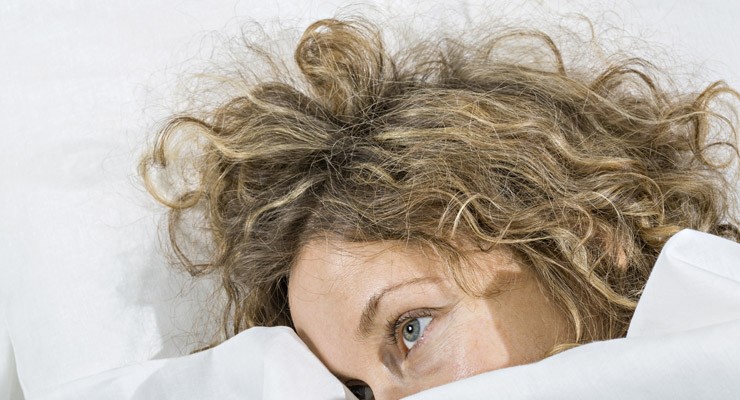 0375_187591150 woman under covers with just her head sticking out