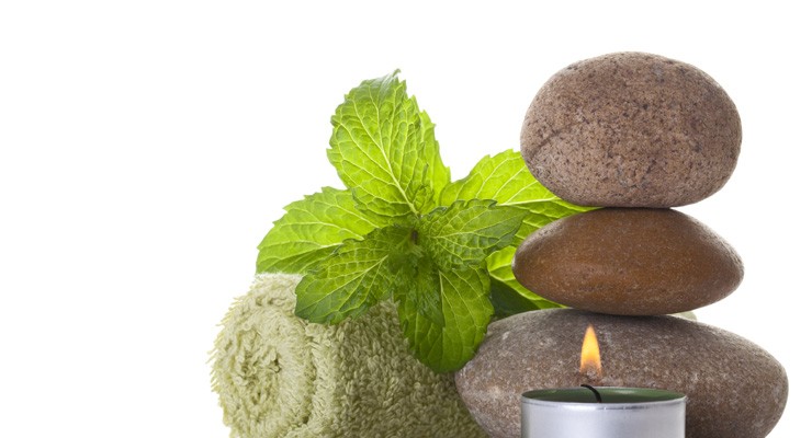0413_183265055 image of rolled towel, candle and smooth stones