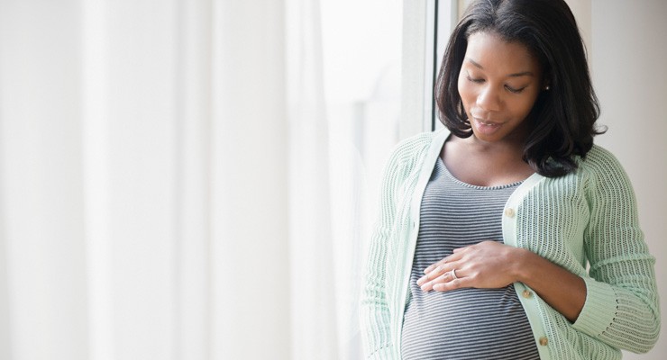 0387_557475475 pregnant woman holding her belly.